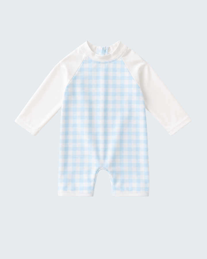 Baby swimsyuit with white sleeves and blue checkered body on a light gray background