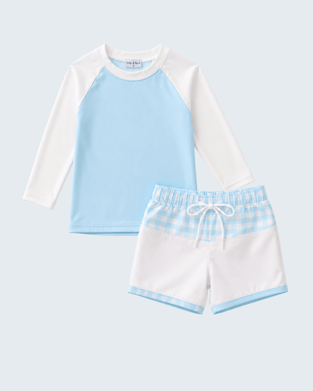 Children's blue and white swim shirt with matching shorts on a light gray background