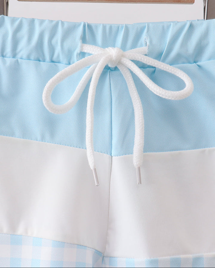 Light blue and white striped shorts with a drawstring on a hanger against a white background