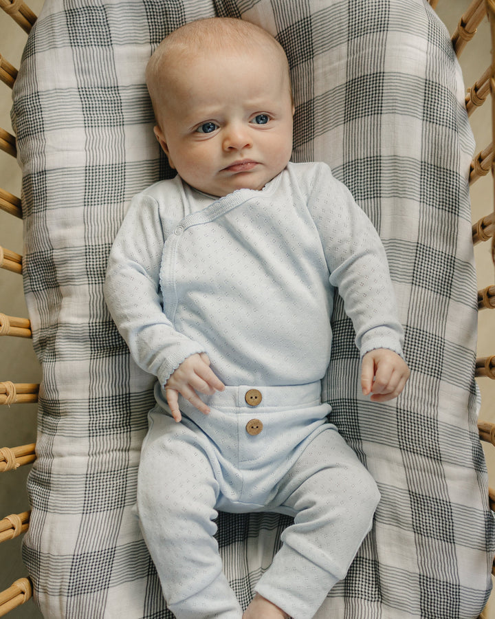 Light gray baby layette outfit with long-sleeve top and button-front pants