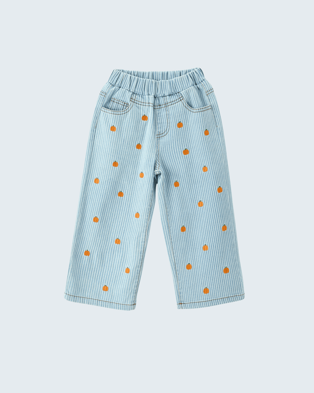 Light blue denim-style pants with thin vertical stripes, an elastic waistband, and small orange embroidered motifs scattered across the front, shown on a plain light gray background.