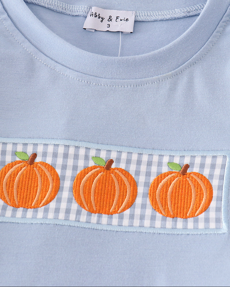 Blue shirt with orange pumpkin embroidery on blue-and-white gingham band