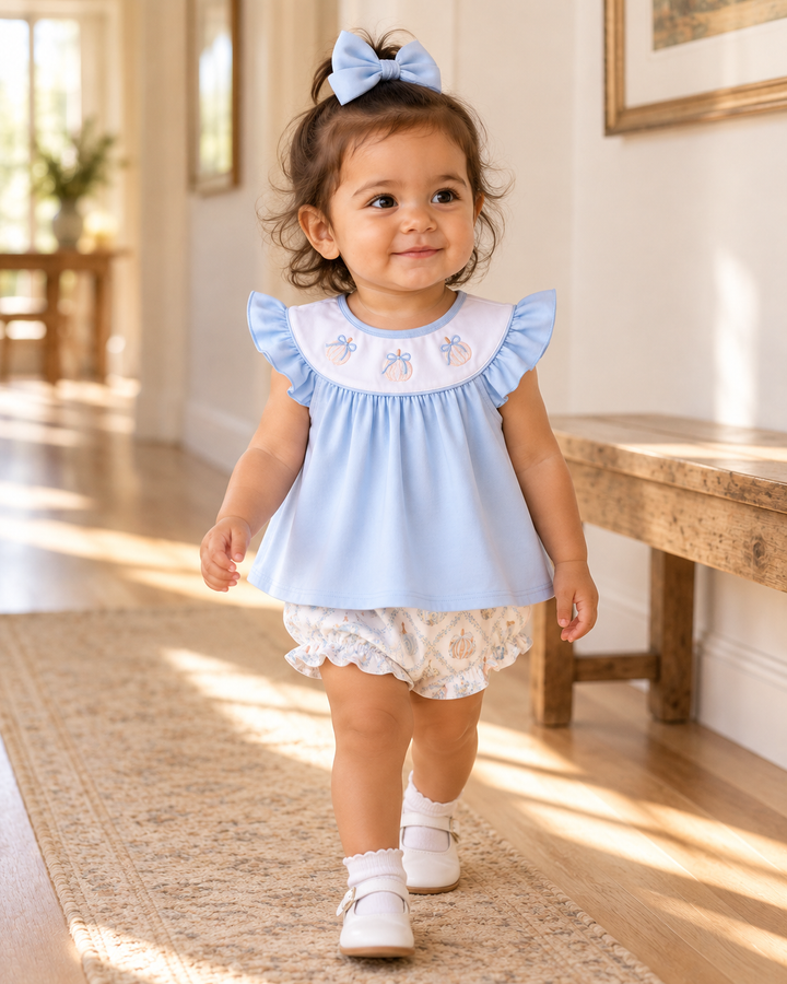 Baby blue ruffle bloomer set on toddler, cap-sleeve dress with pumpkin embroidery and bloomer