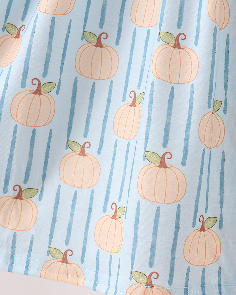 A close-up of a light blue fabric with a repeating pattern of orange pumpkins and vertical blue stripes.