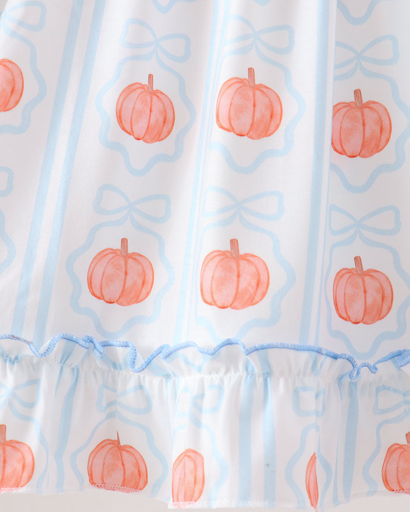 A close-up of a white curtain or fabric panel with a light blue vertical stripe pattern, decorated with watercolor-style orange pumpkins and a ruffled light blue trim along the bottom.