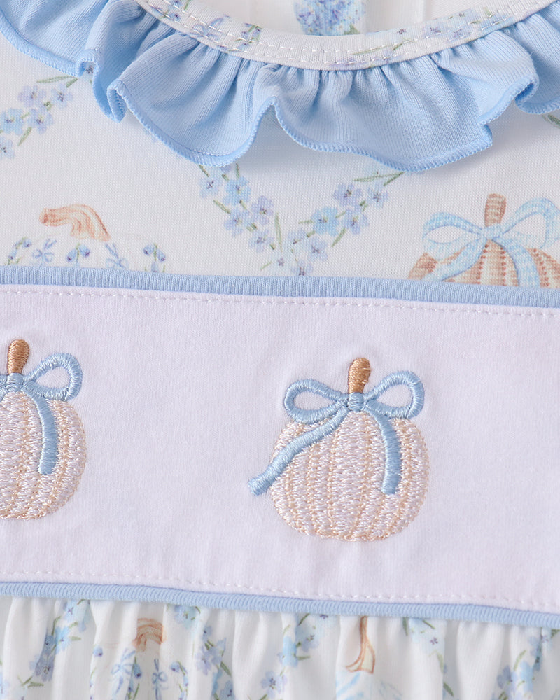 Light blue ruffled neckline and embroidered pumpkin motifs on dress bodice panel