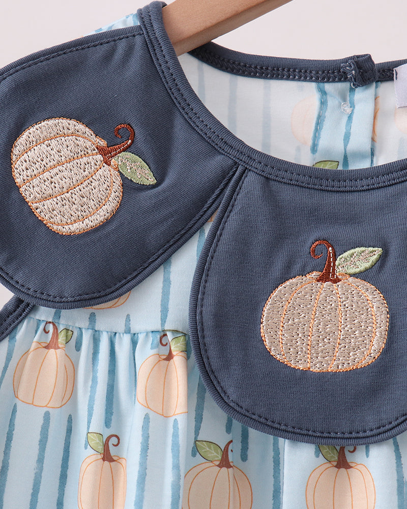 A baby dress with a navy blue Peter Pan collar featuring embroidered pumpkins, paired with a light blue and white striped dress body printed with orange pumpkins.