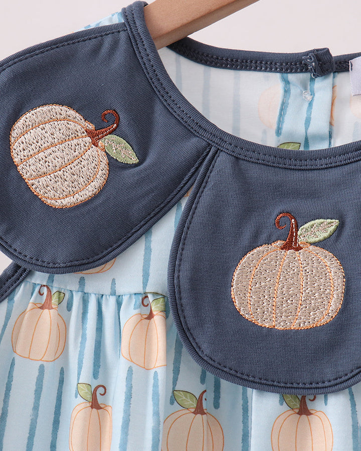 A baby dress with a navy blue Peter Pan collar featuring embroidered pumpkins, paired with a light blue and white striped dress body printed with orange pumpkins.