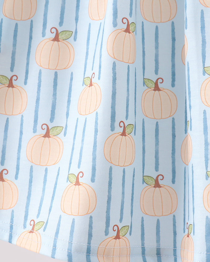 A close-up of a light blue fabric with a repeating pattern of orange pumpkins and vertical blue stripes.