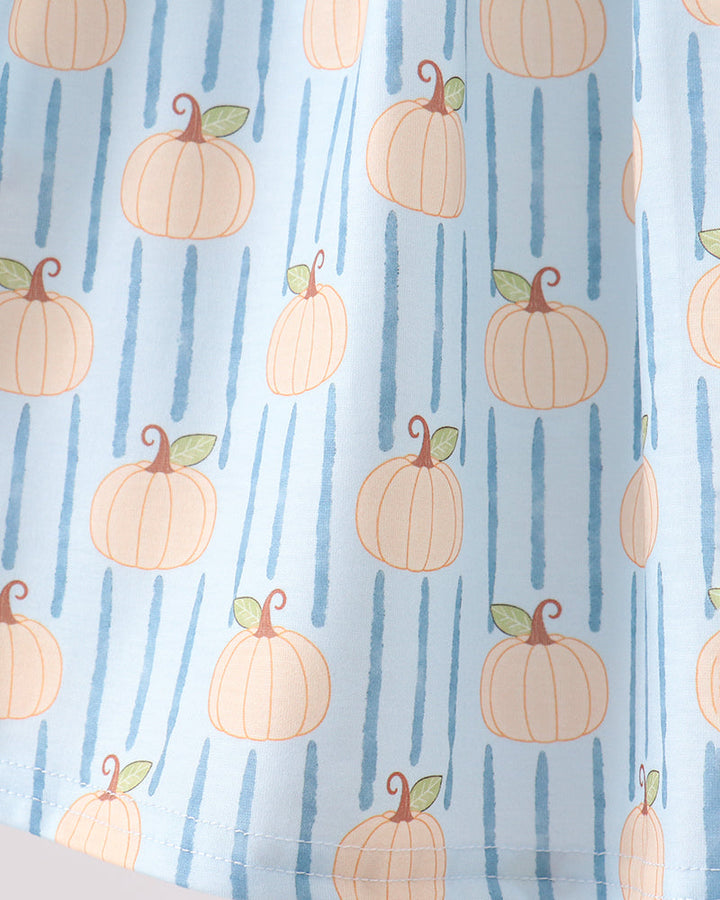 A close-up of a light blue fabric with a repeating pattern of orange pumpkins and vertical blue stripes.