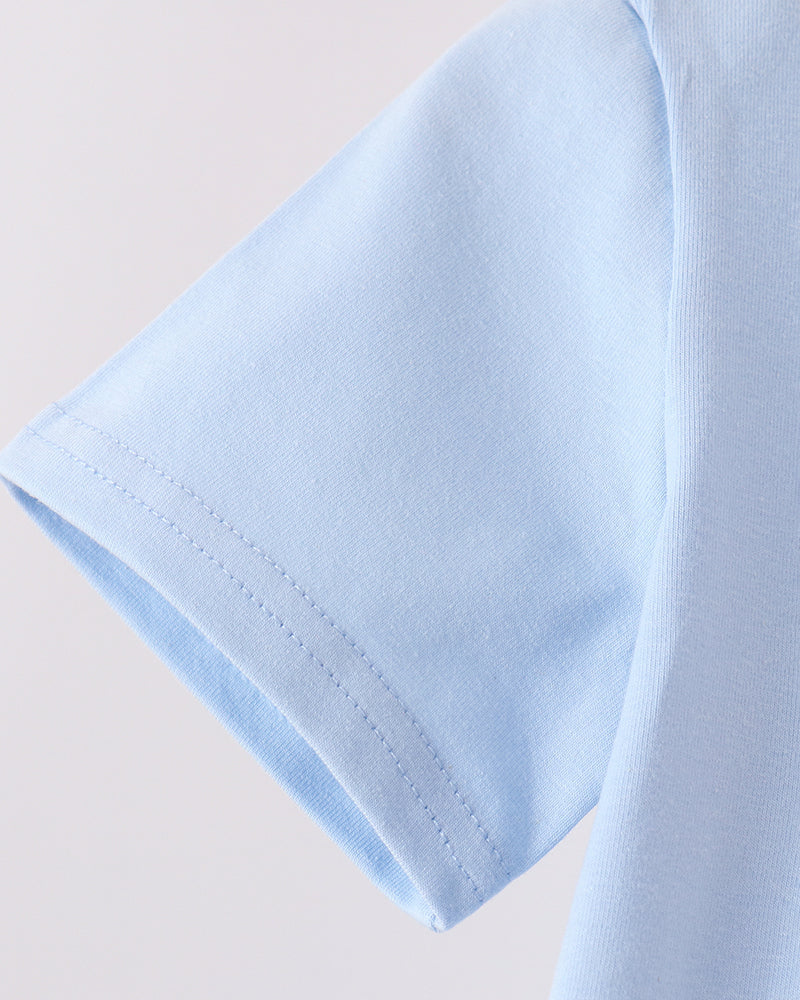 Light blue short-sleeve top with curved sleeve hem and stitched seam detail