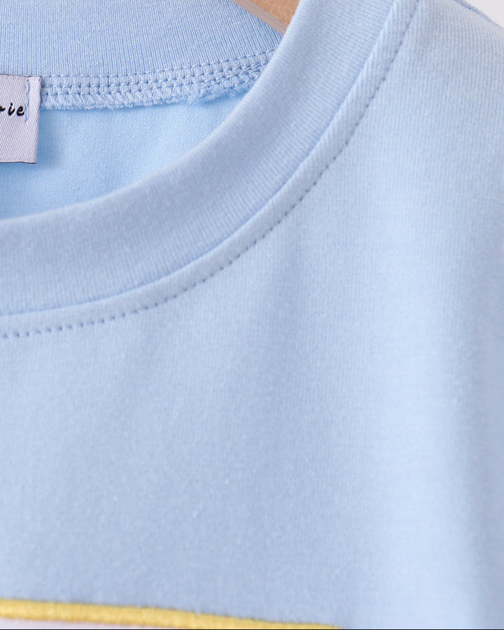 Light blue crew-neck top with ribbed collar and interior tag
