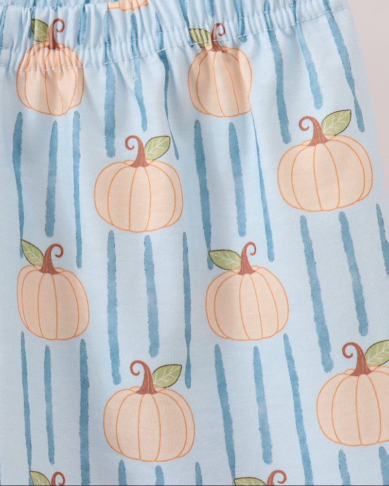Light blue fabric with a repeating pattern of orange pumpkins and vertical blue stripes, featuring an elastic waistband.