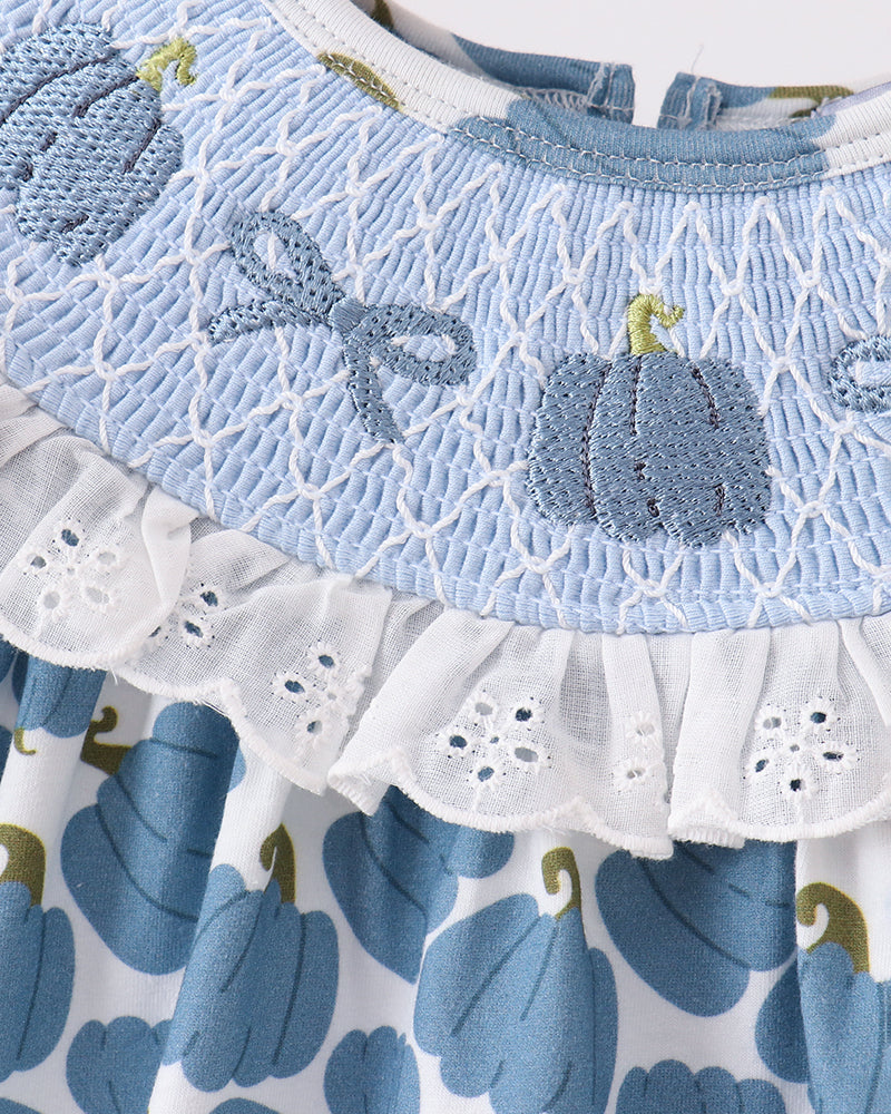 Light blue pumpkin-themed romper with smocked lace bodice and white eyelet ruffle