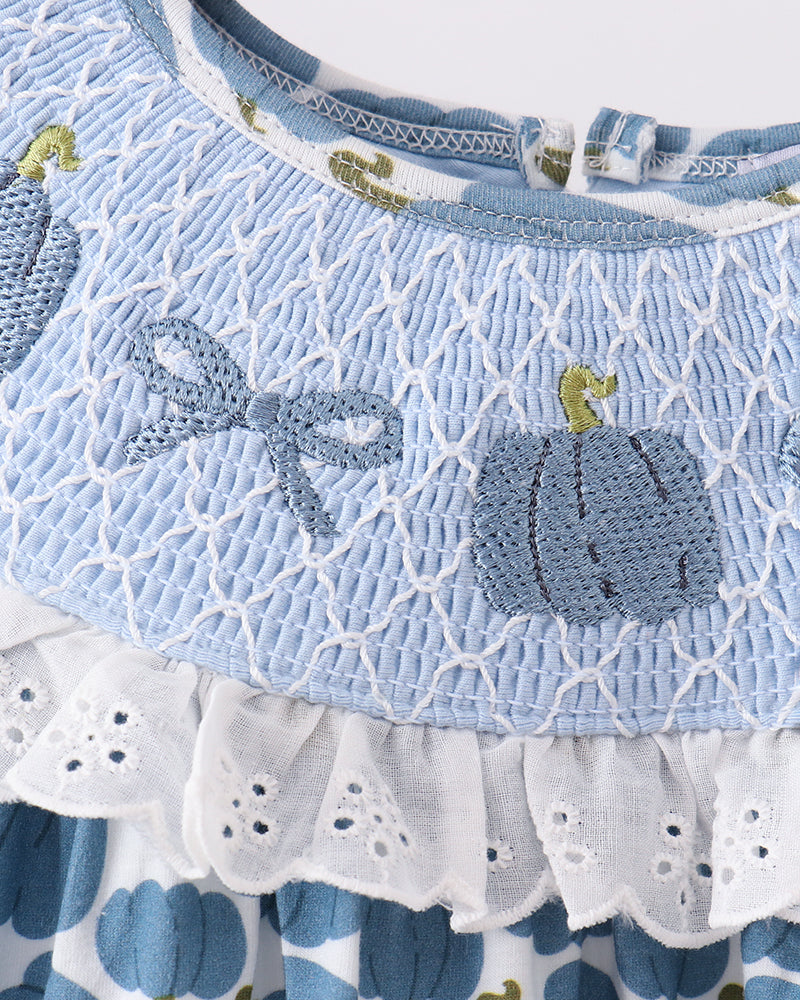 Blue smocked yoke dress with lace trim and pumpkin-themed print skirt
