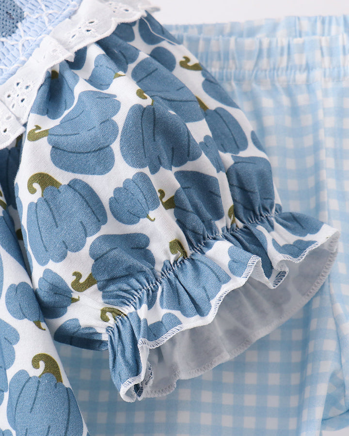 Ruffle-sleeve smocked top with blue pumpkin print and elastic cuffs; gingham pants