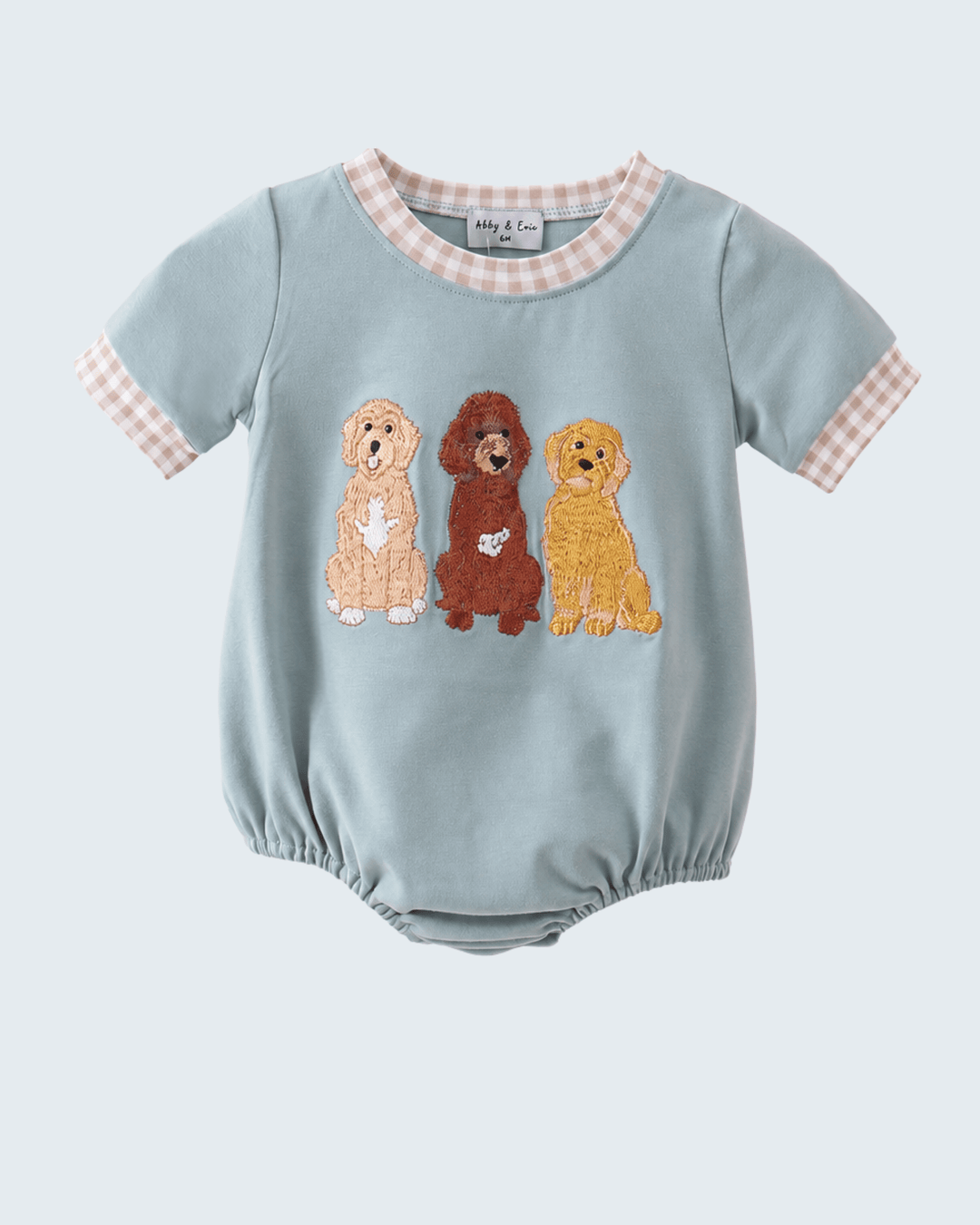 Light blue baby romper with embroidered dogs on a white background