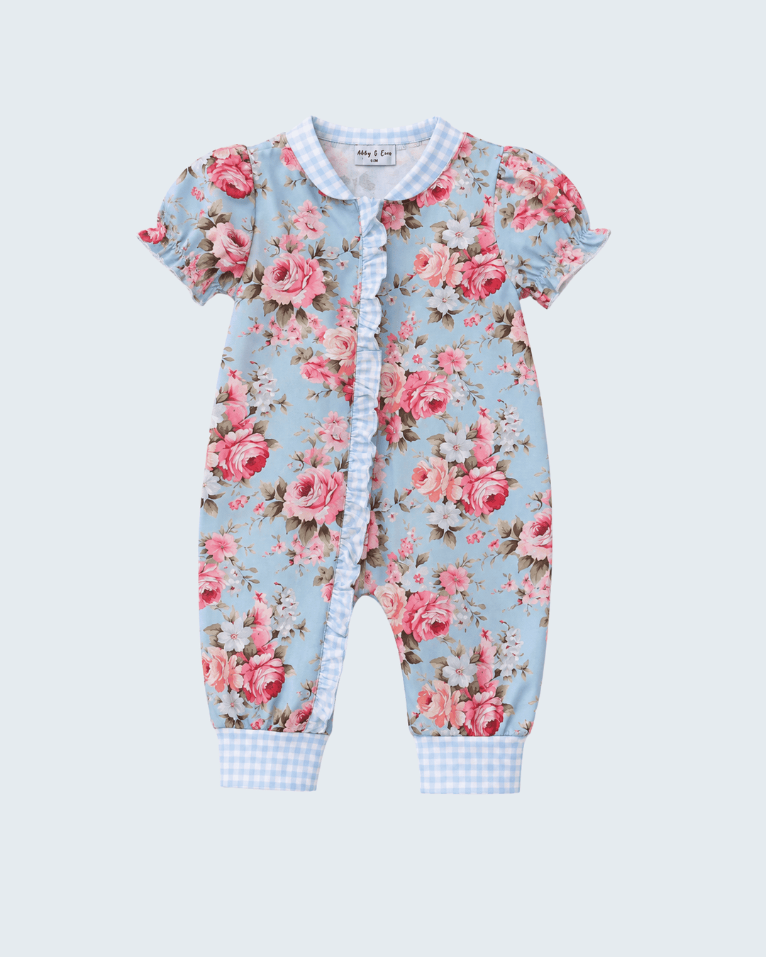 A baby short-sleeve footless romper in a light blue floral print with pink roses, featuring a gingham collar and leg cuffs, and a ruffled snap-button front.