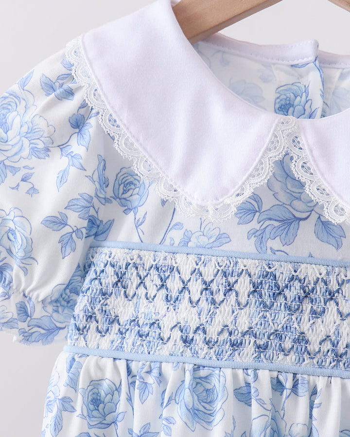 Close up of dress with white collar on wooden hanger