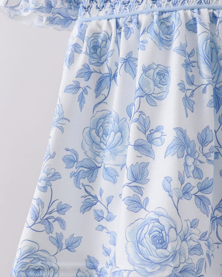 White dress with blue floral pattern on a white background