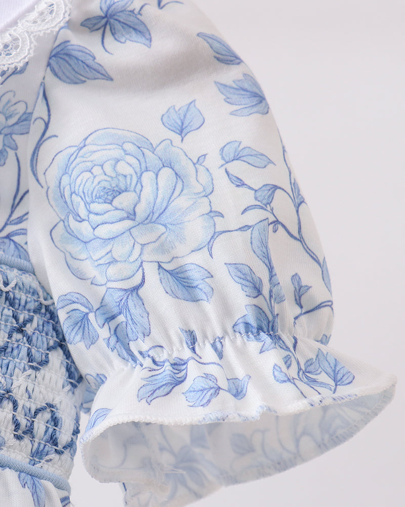 White fabric with blue floral pattern on a white background