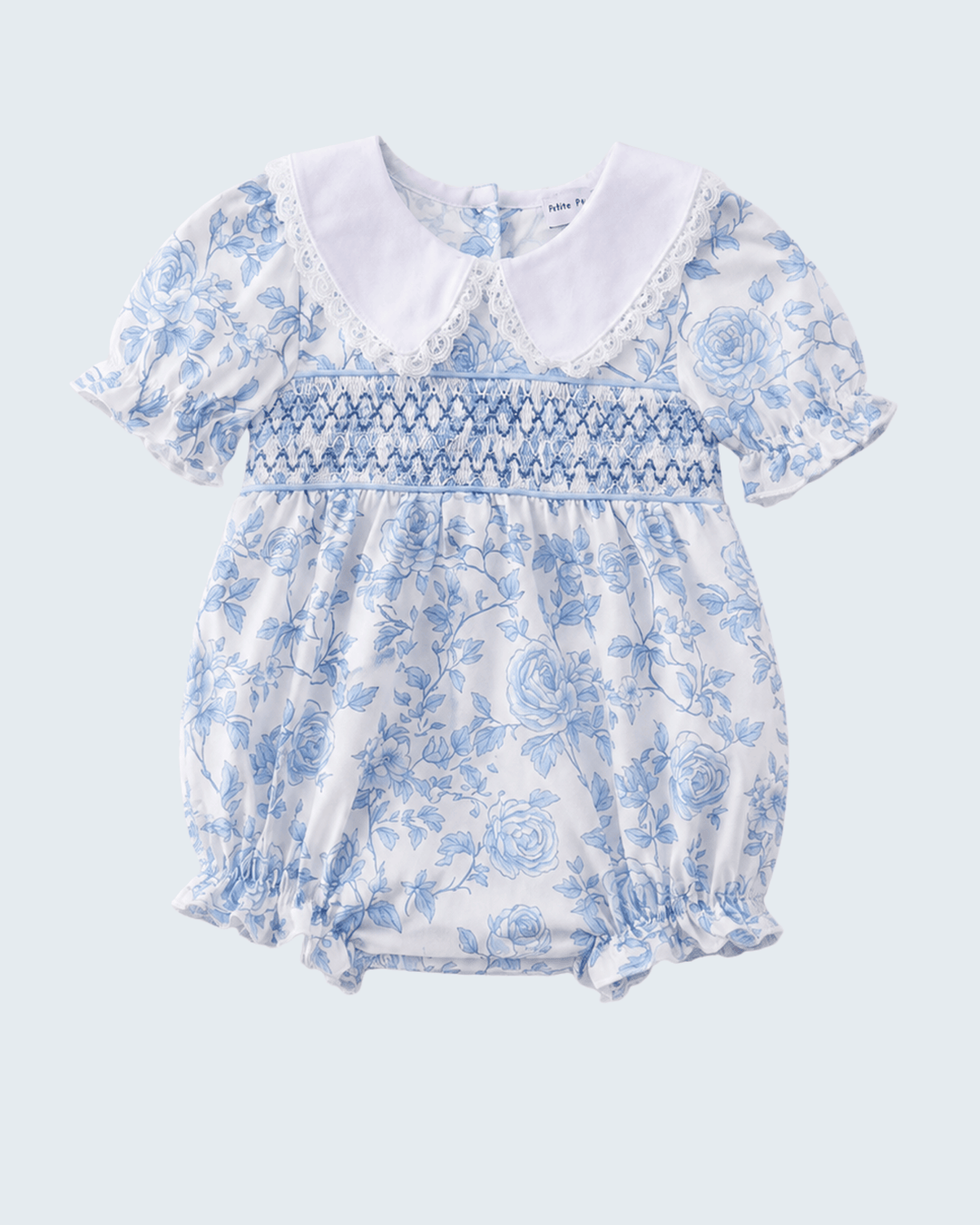 Baby romper with blue floral pattern on a light gray background