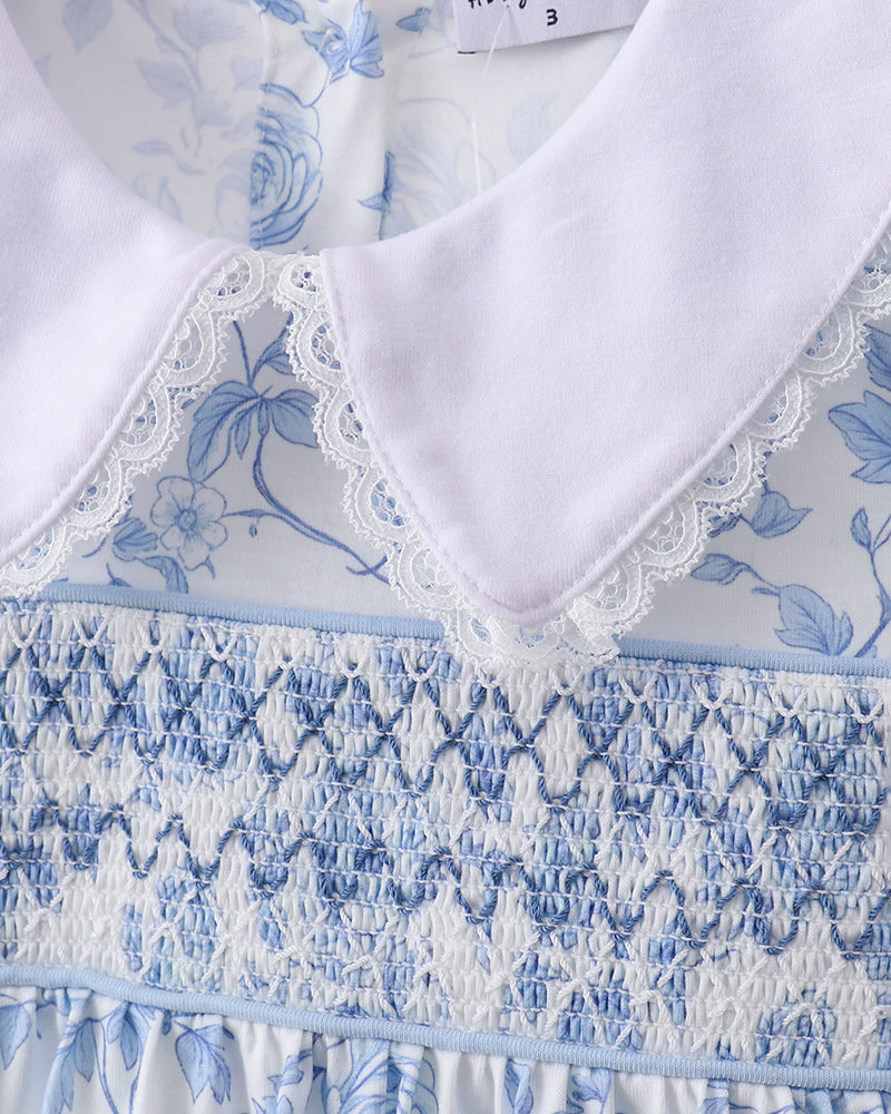 Close-up of a blue and white floral dress with lace trim