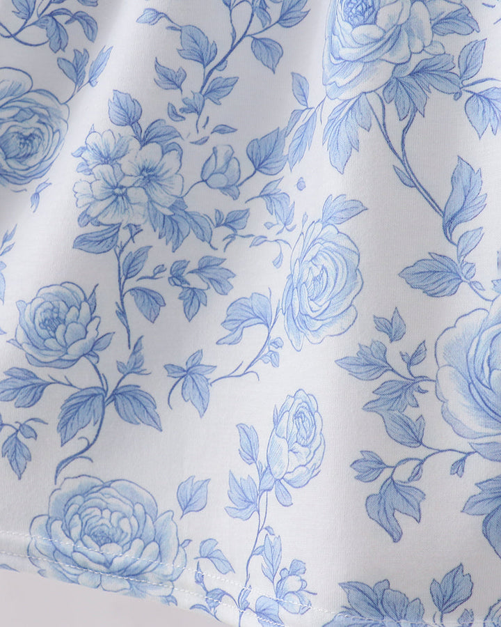 Close-up of blue floral pattern on white fabric