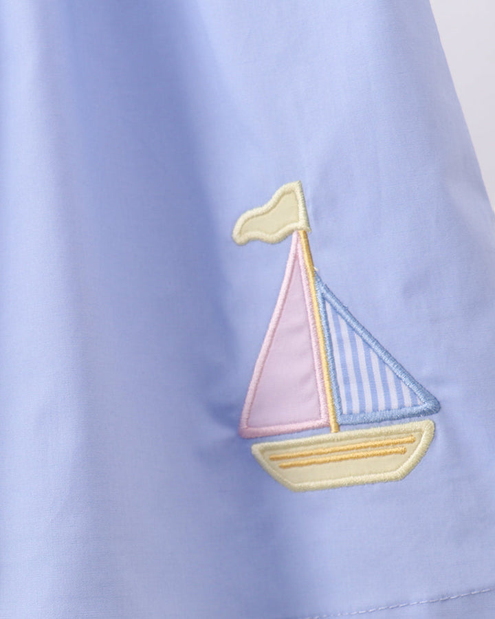 Light blue dress with sailboat applique embroidery on side