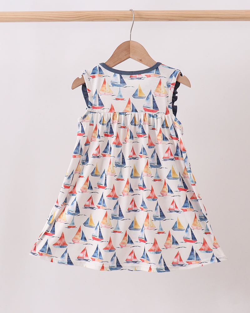 Blue Sailboat Embroidered Dress on wooden hanger