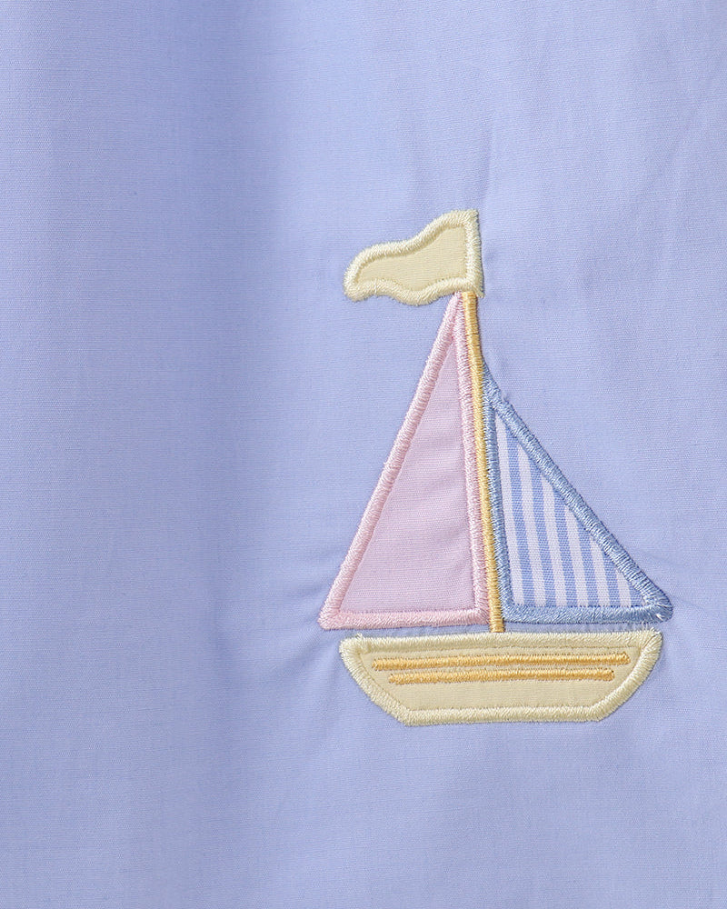 Light blue dress with sailboat applique embroidery in yellow, blue, and pink
