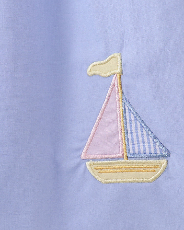 Light blue dress with sailboat applique embroidery in yellow, blue, and pink