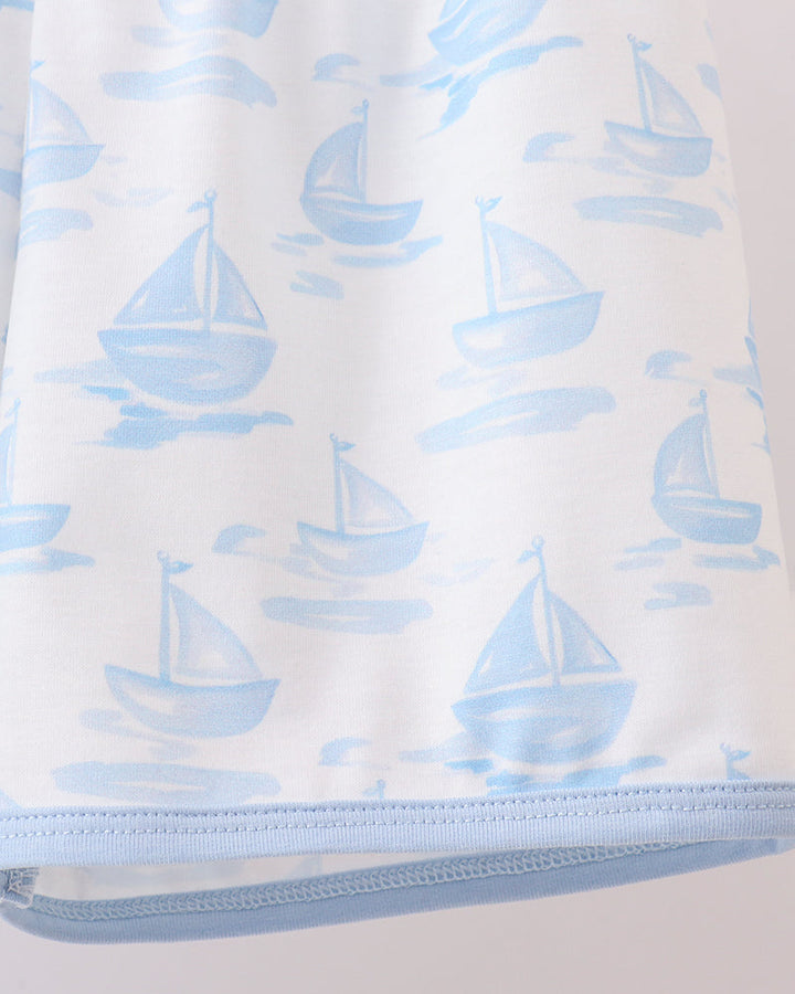 Shorts with blue sailboat pattern on a white background