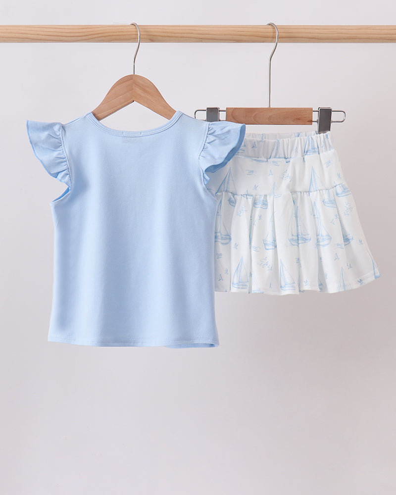Light blue ruffle-sleeve top and sailboat-print tiered skort set, front view