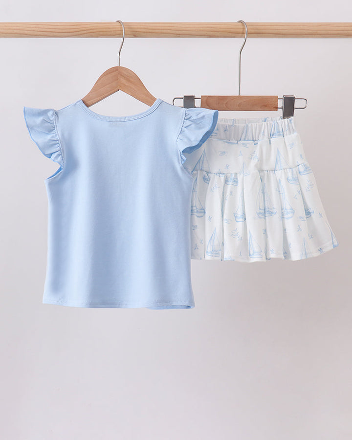 Light blue ruffle-sleeve top and sailboat-print tiered skort set, front view