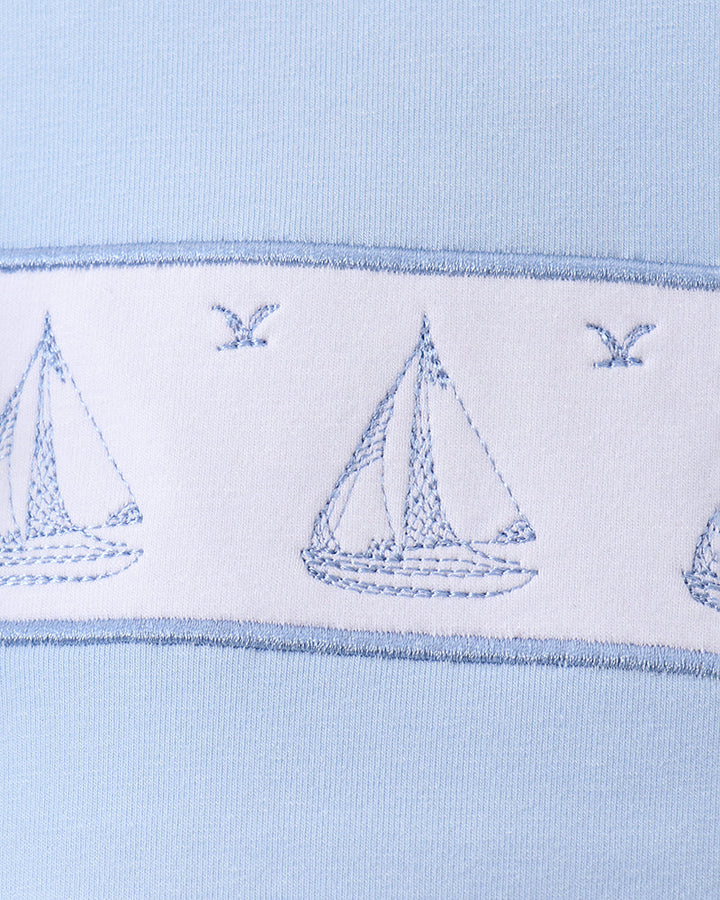 Blue sailboat embroidery on light blue knit T-shirt