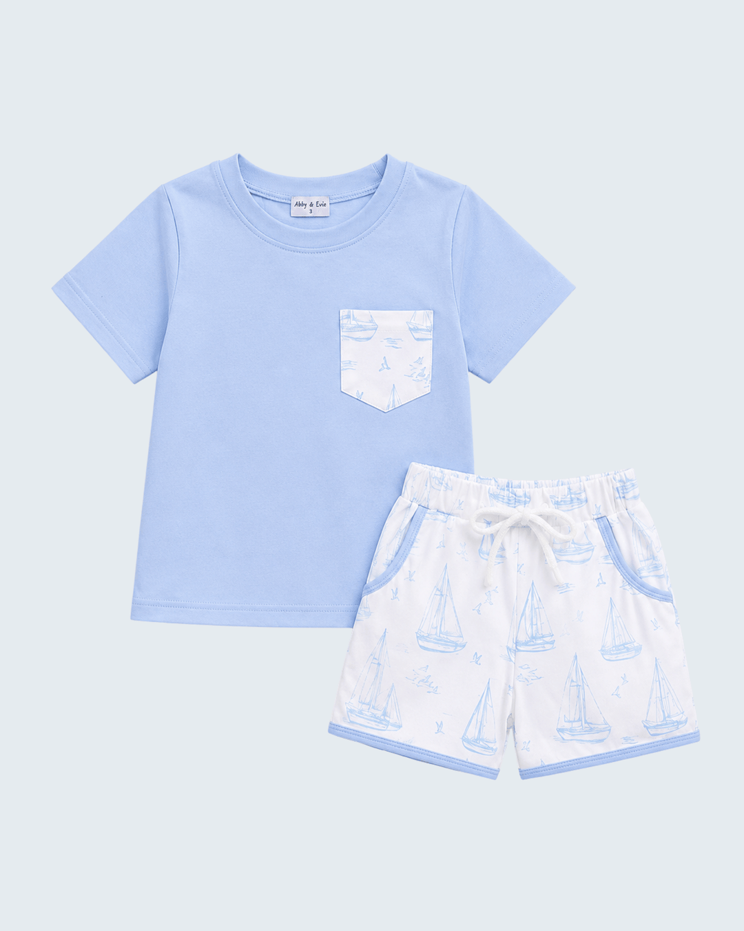 Light blue sailboat T-shirt with chest pocket and matching printed drawstring shorts
