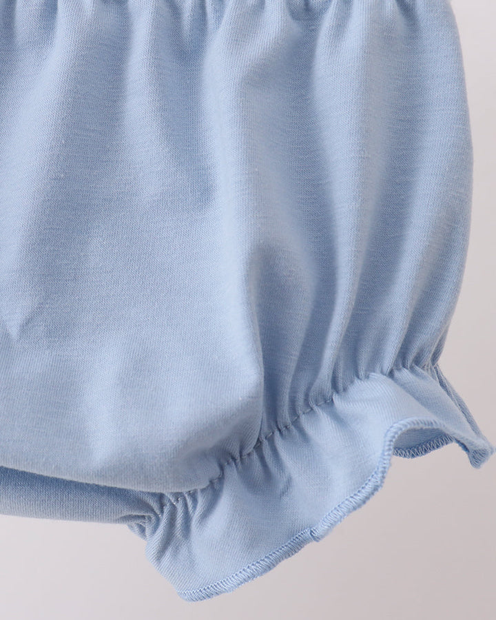 Light blue fabric with a textured surface on a beige background