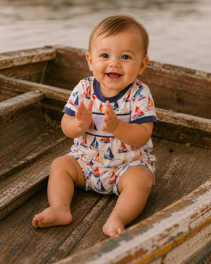Baby boy sitting in an old wooden boat