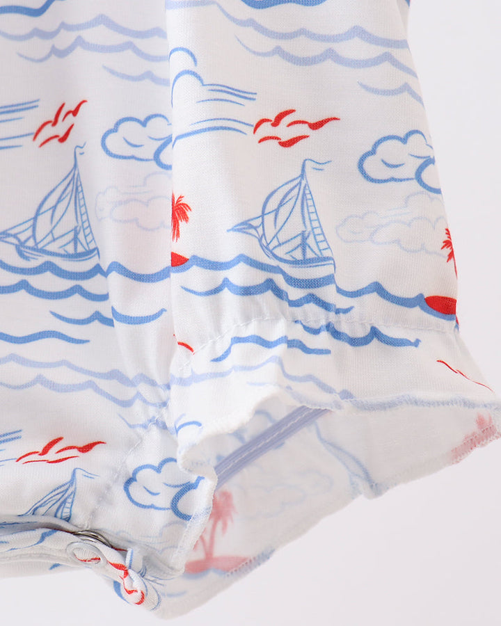 Romper with nautical pattern featuring sailboats, clouds, and seagulls on a white background.