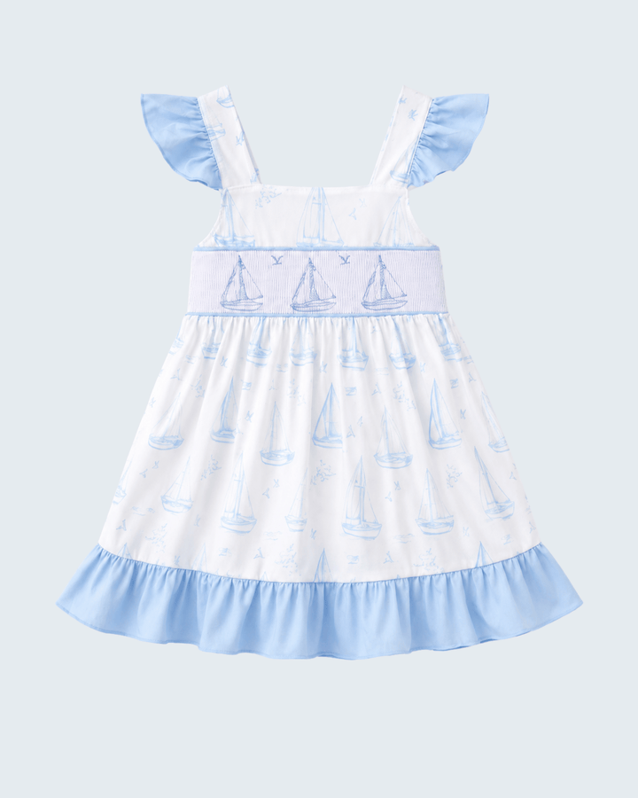 Blue Sailboat Smocked Ruffle Dress on light blue background