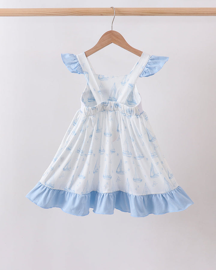 Blue Sailboat Smocked Ruffle Dress on wooden hanger
