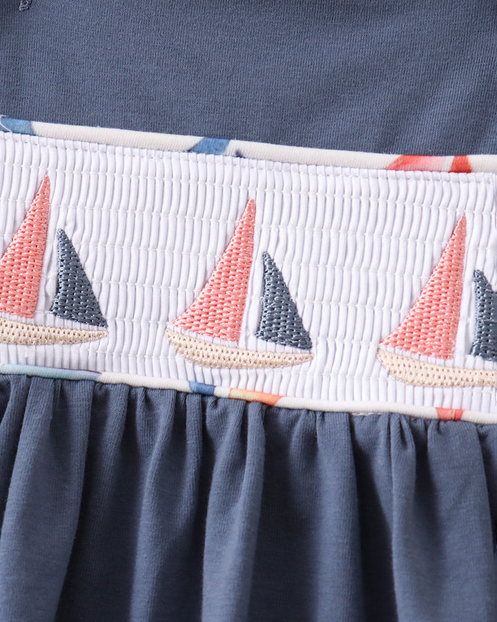 Blue dress with sailboat embroidery and smocked details