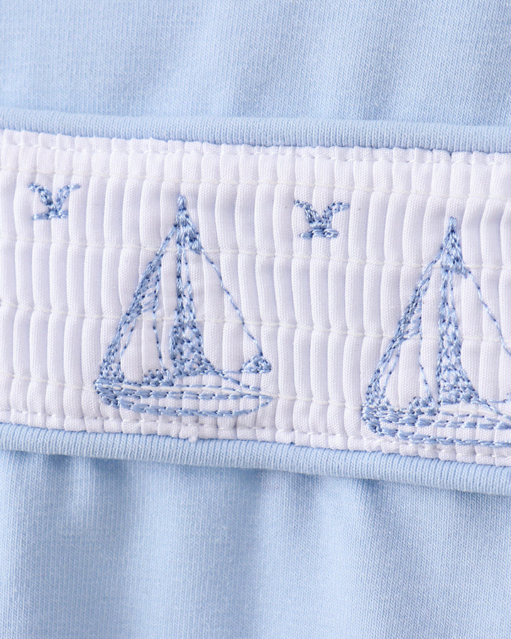 Blue shirt with embroidered sailboats and smocked detailing