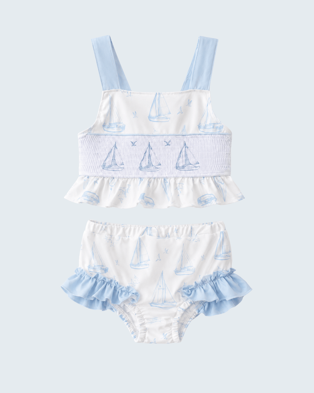 Blue Sailboat Smocked Two-Piece Swimsuit on light grey background