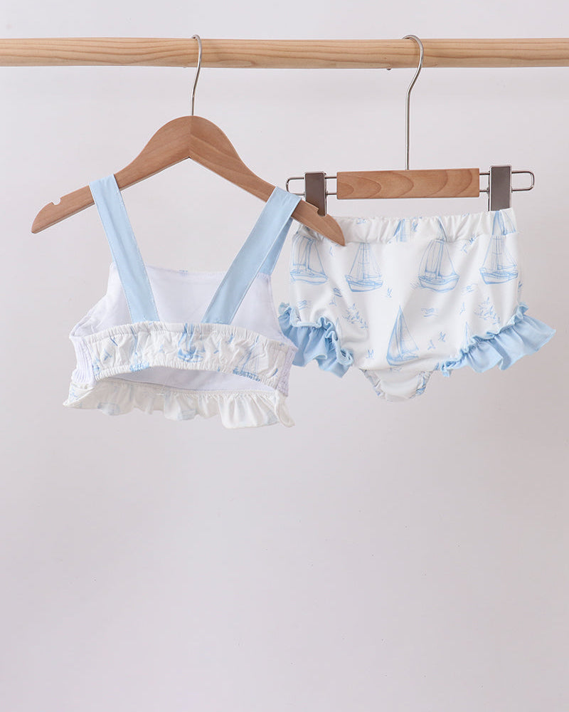 Blue Sailboat Smocked Two-Piece Swimsuit on wooden hanger