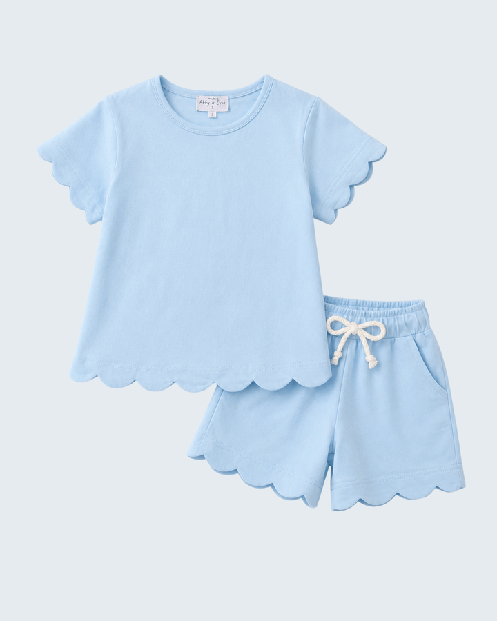 Light blue pajama set with scalloped edges on a light gray background