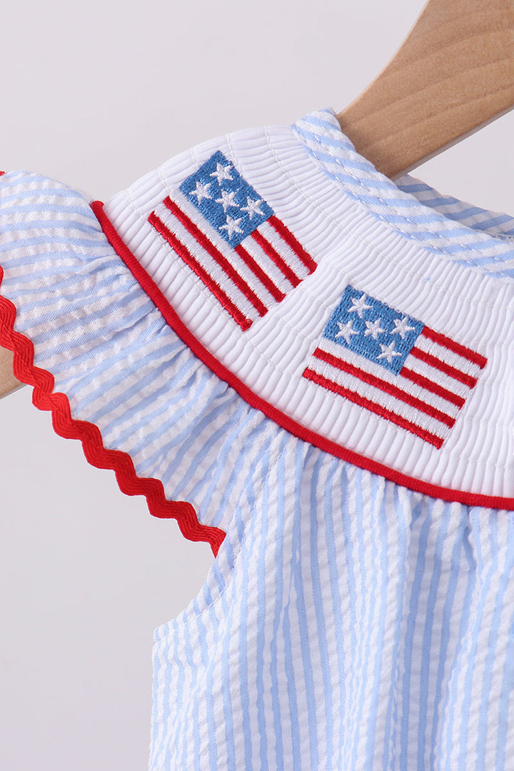 Baby romper with American flag design on a plain background
