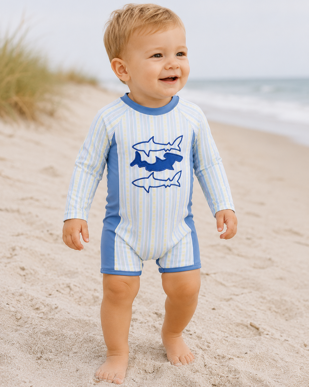 Baby boy on beach wearing Blue Shark Applique Stripe Swimsuit