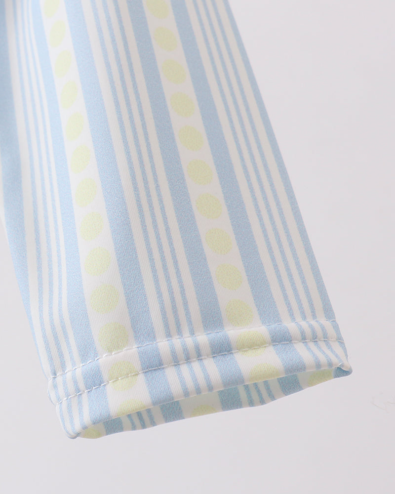 Close-up of a folded fabric with blue and yellow stripes on a white background